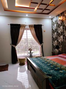 a bedroom with a large bed and a large window at VIP Luxury Room's in Lahore