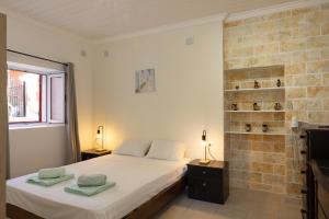 A bed or beds in a room at The Village Cottage - Benitses
