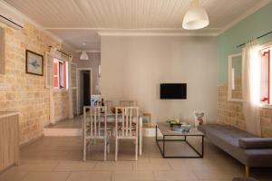 A television and/or entertainment centre at The Village Cottage - Benitses