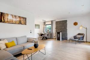 a living room with a couch and a table at Eifel-resort in Waxweiler