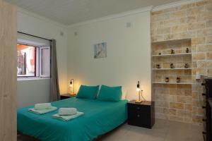 A bed or beds in a room at The Village Cottage - Benitses