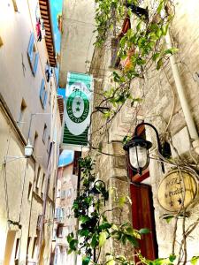 a clock on the side of a building with a street light at Hotel S. Ercolano in Perugia