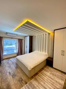 a bedroom with a bed and a large window at Hotel Customised flat Near Taksim/Nişantaşi in Istanbul