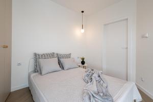 um quarto branco com uma cama com um cobertor em 2HomeRent Apartamenty Urocza 10 em Bydgoszcz