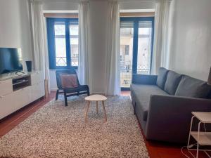 a living room with a couch and a table at Imperial Douro Apartamento 1 in Peso da Régua