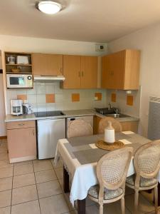 a kitchen with a table and chairs in a kitchen at Charm Burgundy in Levernois