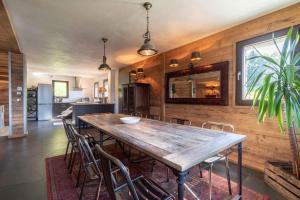 a dining room with a wooden table and chairs at Chalet Apalosa - Montvalezan, La Rosière in Montvalezan +7 photos