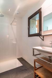 a bathroom with a sink and a shower at Chalet Apalosa - Montvalezan, La Rosière in Montvalezan