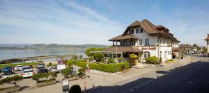 a building on the side of a street with a parking lot at Hotel Schiff am See in Murten