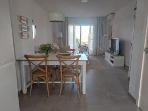 a kitchen and dining room with a table and chairs at NEW!! Bonito adosado en Zahara de los Atunes in Zahara de los Atunes