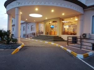 a lobby of a building with a staircase and a building at Nizwa Hotel Apartments in Nizwa