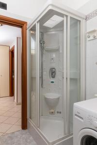 a bathroom with a toilet in a glass enclosure at Spacious Exclusive Apartment in Pioltello