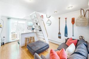 a living room with a couch and a kitchen at Cozy Cape Condo in Provincetown