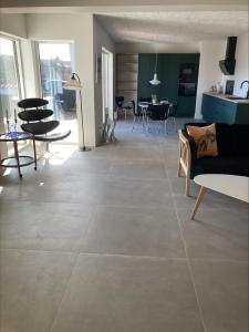 a living room with a large tile floor at Poppel alle 2 b Hirtshals in Hirtshals