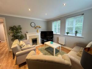 sala de estar con 2 sofás y chimenea en Contractors welcome GF flat sleeps 4 with parking by Eagle Owl Property, en Crawley