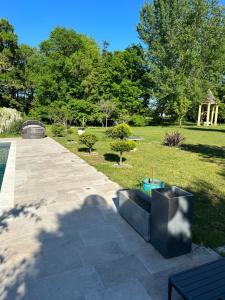 a shadow of a person taking a picture of a garden at La villa bella in Abzac