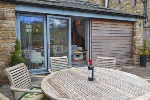 a bottle of wine sitting on a wooden table at Jaycot in Alston