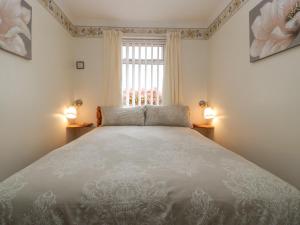 a bedroom with a large bed and a window at Blorenge in Abergavenny