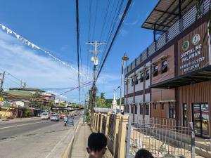 a group of people walking down a city street at Near Airport Transient Inn - 2 Bedroom Suite in Puerto Princesa City