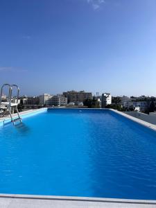 a large blue swimming pool on top of a building at Alex Residence in Larnaca