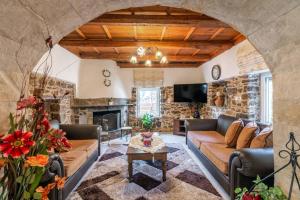a living room with a couch and a fireplace at Traditional House with Private Pool in Rethymno