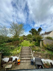 a set of stairs leading up to a yard at The Crown Inn in West Down