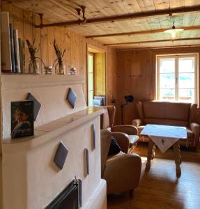 a living room with a couch and a table at Farmhouse with a stunning view over the dolomites in Villnoss