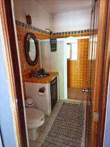a bathroom with a toilet and a sink and a shower at La Posada Pacifica in Puerto Vallarta