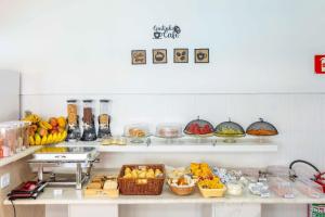 a buffet with many different types of fruits and vegetables at Pousada Sol da Enseada Guarujá in Guarujá