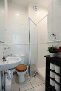 a bathroom with a toilet and a sink and a shower at LORD MERIT GUEST HOUSE KING'S CROSS GRAYS INN ROAD in London