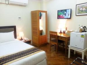 A bed or beds in a room at Grand Laurel Hotel