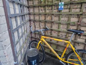 uma bicicleta amarela estacionada ao lado de uma parede em West Beck House - Newcastle 6 em North Shields