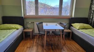 a room with two beds and a table and chairs at 3611 HAUS HABRUCK Top 2 F in Habruck