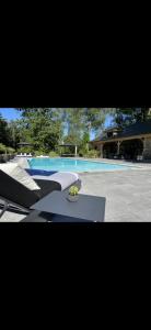 a swimming pool with a slide in front of it at Magnifique chalet en bois avec piscine et jacuzzi in Court-Saint-Étienne