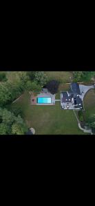 an aerial view of a large house with a swimming pool at Magnifique chalet en bois avec piscine et jacuzzi in Court-Saint-Étienne