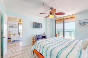 a bedroom with a bed and a ceiling fan at Sunset Shores in St Pete Beach