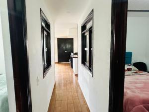 a hallway leading to a room with a bed and a bedroom at Casa Hotel Camino Real in Guadalupe