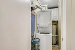a kitchen with a microwave oven and a refrigerator at Coastal Condo on Beach with Community Pool Access! in Myrtle Beach