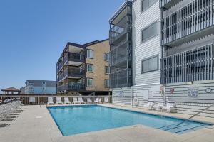 a swimming pool in front of a apartment building at Coastal Condo on Beach with Community Pool Access! in Myrtle Beach