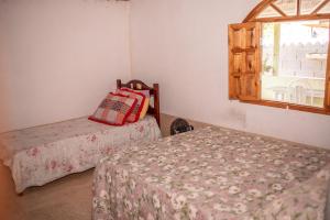 Giường trong phòng chung tại Chacara com muito conforto em Alto Caparao MG