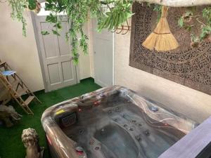 a jacuzzi tub in the corner of a room at La P'tite maison Les Tourelles in Caffiers +44 photos