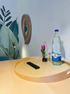 a bottle of water and a remote control on a table at schloss1 in Selb