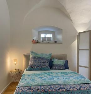 a bedroom with a bed with blue sheets and a mirror at schloss1 in Selb