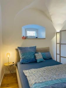 ein Schlafzimmer mit einem Bett mit blauen Kissen und einem Spiegel in der Unterkunft schloss1 in Selb