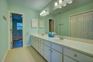 a bathroom with two sinks and a large mirror at Ingen Trafikk in Southport +20 photos