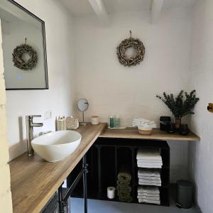 a bathroom with a counter with a sink and mirrors at Vakantiehuis 2 Schouwenberg in Swalmen