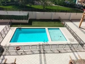 an overhead view of two swimming pools on a building at Piso turístico en Granada. Zona Palacio Deportes in Granada