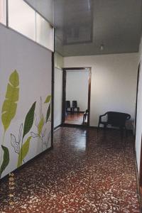 an empty room with a hallway with a chair and a table at hostal el gran amparo in Sevilla