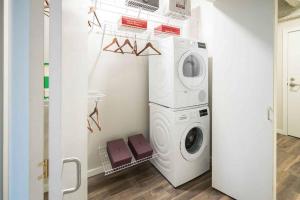 a laundry room with a washer and dryer at DT Delight Downtown Living One-bedroom Endless Access in Cleveland