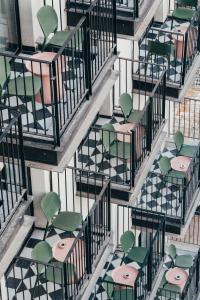 an overhead view of green chairs and tables on stairs at Hotel Shoshana - Adults Only in Eilat